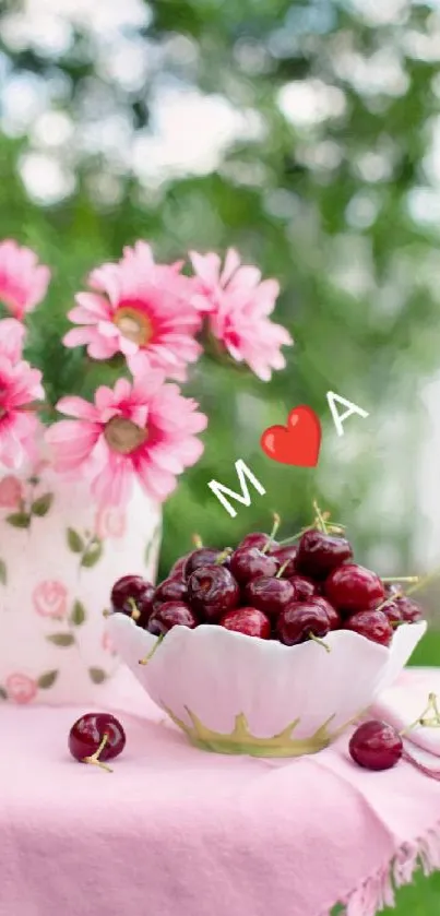 Pink flowers and cherries in a bowl on a table.