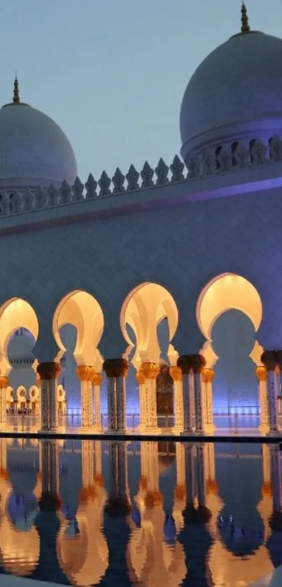 Elegant mosque reflecting on water at dusk.