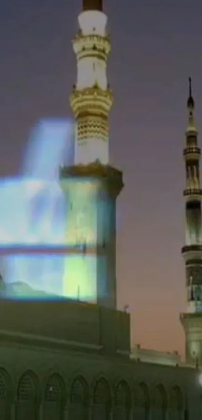 Mosque tower against twilight sky, beautifully illuminated.