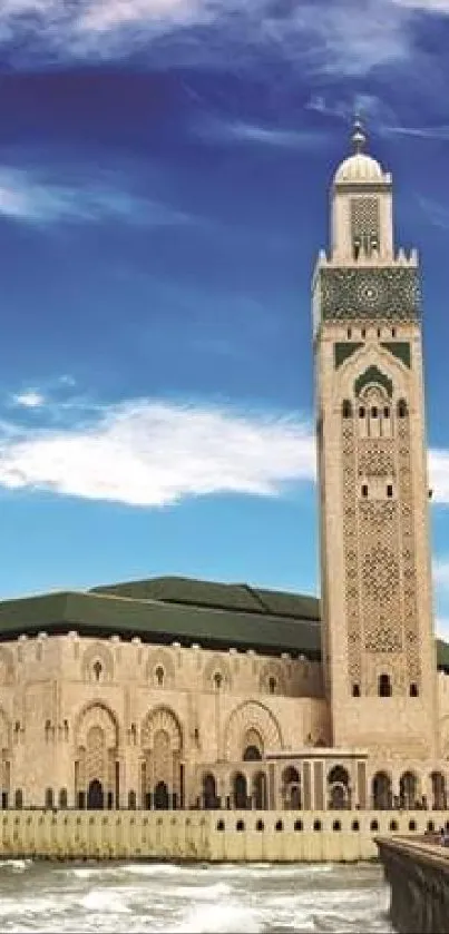 Mosque by the ocean with blue sky and waves.