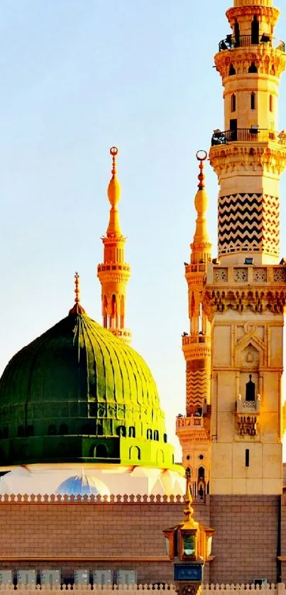 Mobile wallpaper of a mosque with a green dome and golden minarets.