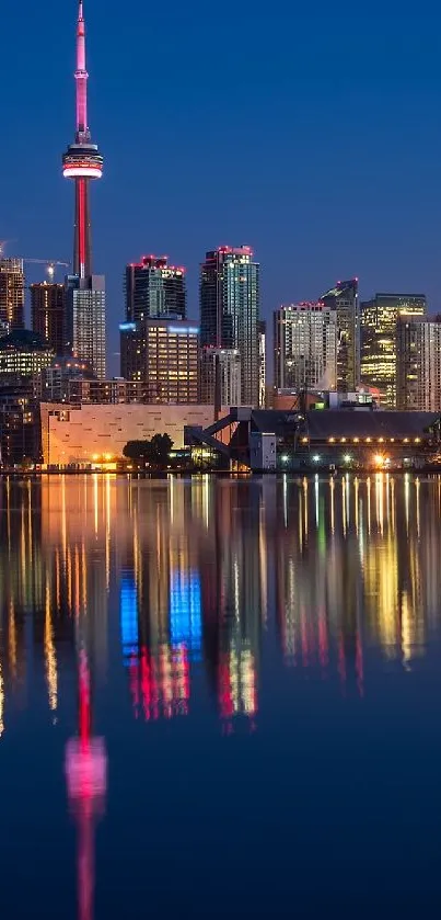 City skyline at night with colorful reflections on the water.