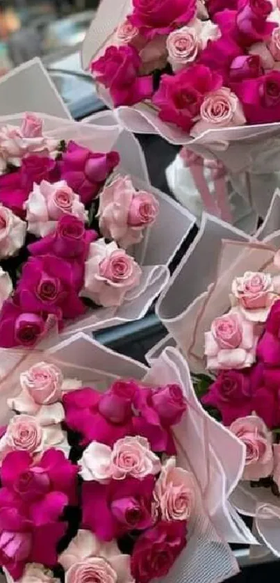 Five vibrant pink rose bouquets elegantly arranged.