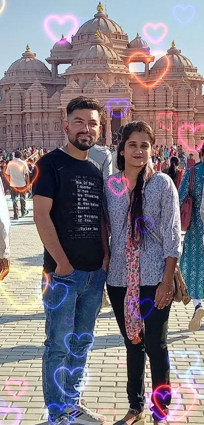 Two people posing at a temple site.