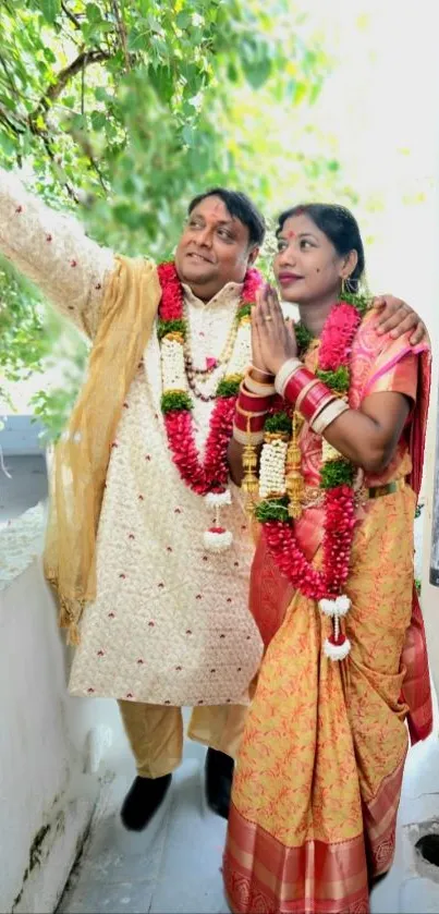 Couple in traditional wedding attire celebrating outdoors.