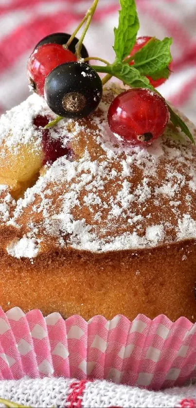 Delicious muffin topped with berries on a checkered cloth.