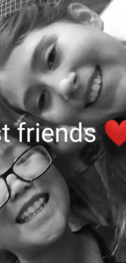 Two friends smiling in a black and white photo with emojis.