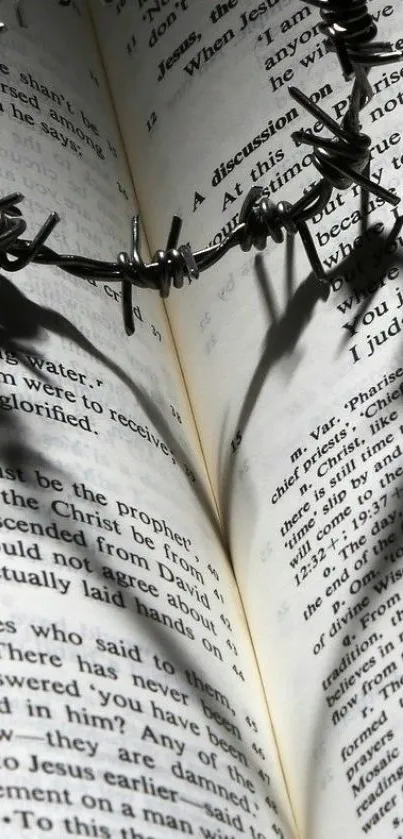 Bible open with barbed wire casting shadow