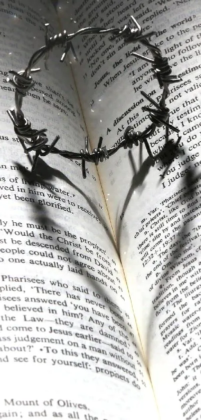 Bible open with a crown of thorns casting a heart shadow mobile wallpaper.