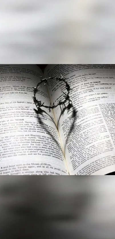 Open Bible with heart shadow made by a barbed wire loop, symbolizing faith and love.