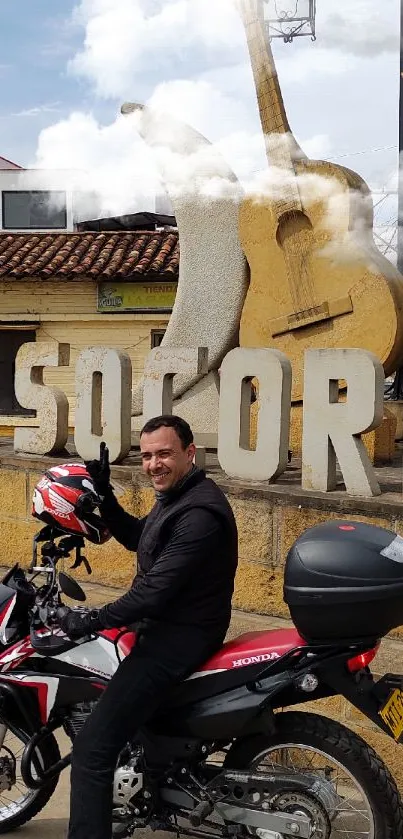 Motorcyclist by El Socorro landmark, vibrant cultural scenery.