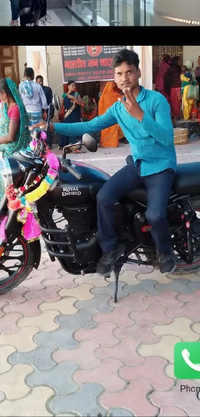 Man on a decorated motorcycle at a lively event.