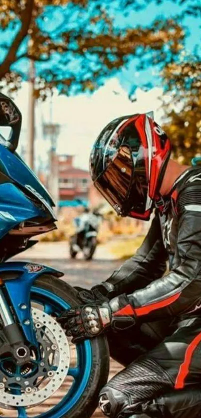 Biker kneeling beside a blue motorcycle.