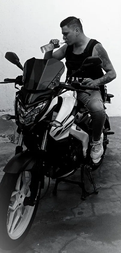 Black and white image of a biker sitting on a motorcycle.