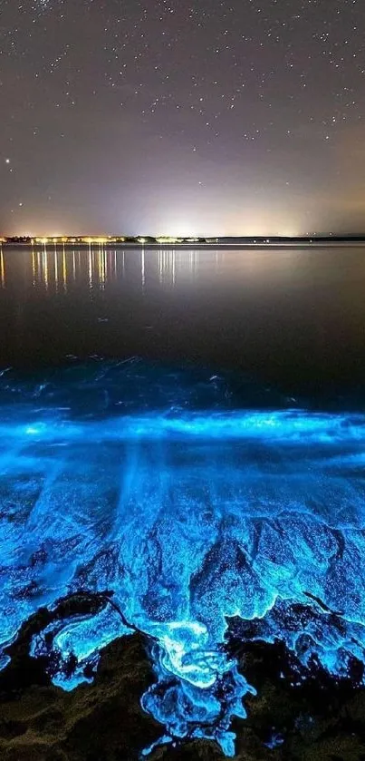 Bioluminescent ocean with starry night sky wallpaper.