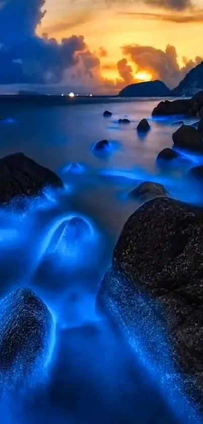 Bioluminescent ocean rocks at sunset with glowing blue hues.