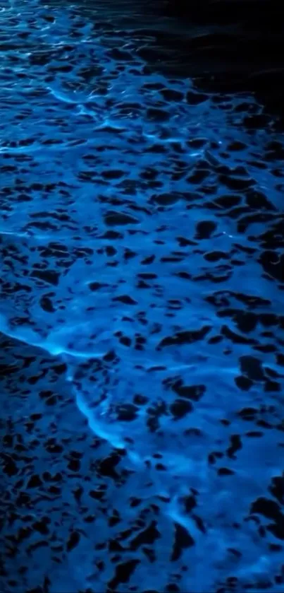Bioluminescent ocean waves glowing in the night.