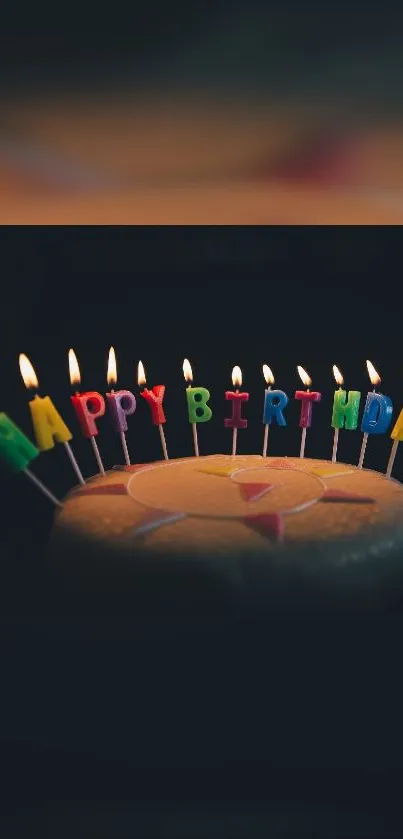 Birthday cake with candles and colorful 'Happy Birthday' letters.