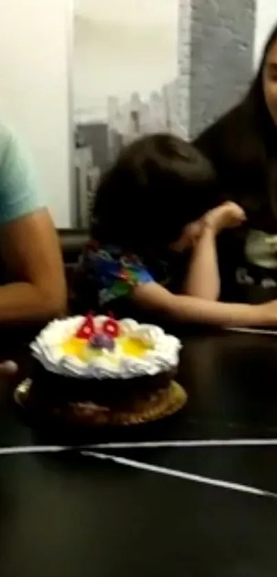 Family celebrates a birthday with a cake.