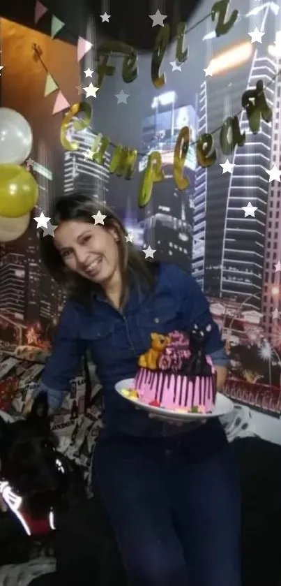 Woman holding birthday cake with balloons and city skyline backdrop.