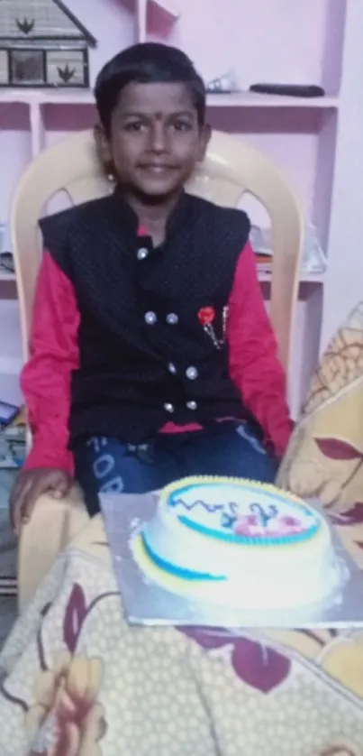 Smiling child with cake at birthday celebration.