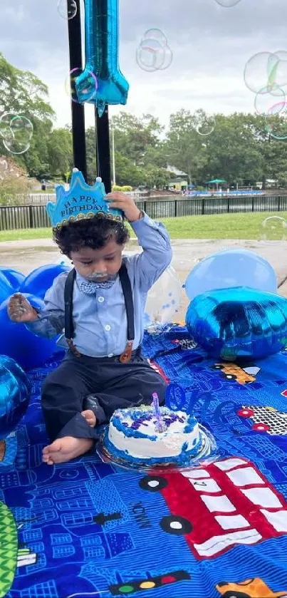 Child's birthday party by a lake with blue balloons and a cake.