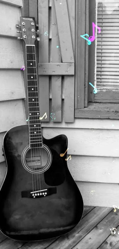 Black acoustic guitar resting on rustic porch with wooden panels.