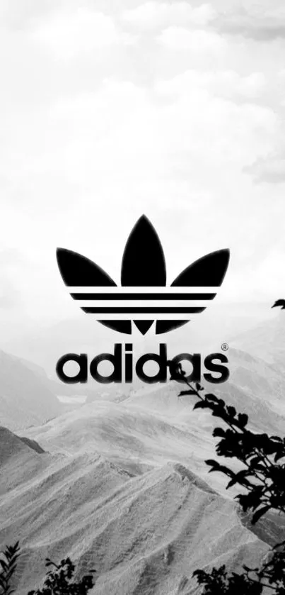 Black and white Adidas logo with mountain backdrop.