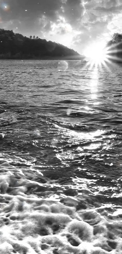 Black and white beach sunset with ocean waves and dramatic clouds.