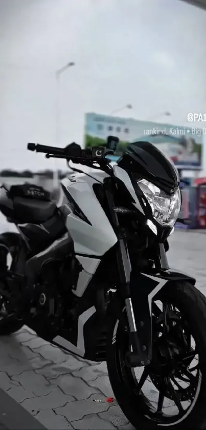 Black and white motorcycle parked in urban setting.