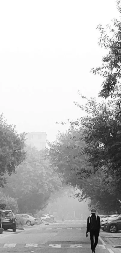 Black and white city street with lone figure walking.