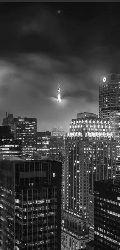 Black and white night cityscape with illuminated skyscrapers.