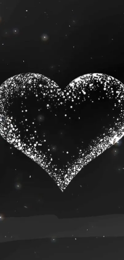 Black and white heart with sparkling effect on a dark background.