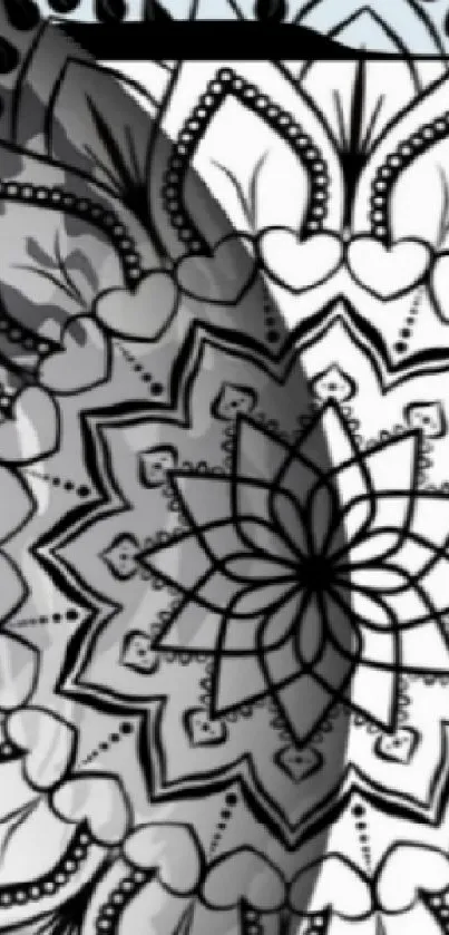 Intricate black and white mandala design on wallpaper.