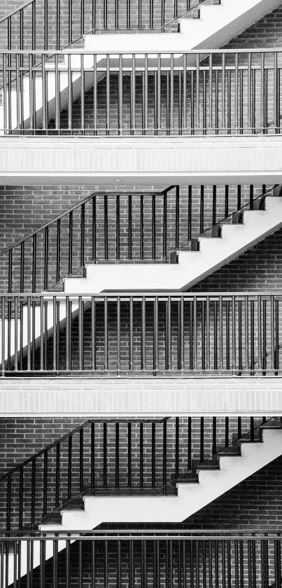 Monochrome photo of a patterned staircase with brick wall background.