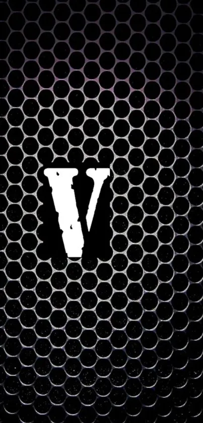 Bold 'V' on black honeycomb pattern wallpaper.