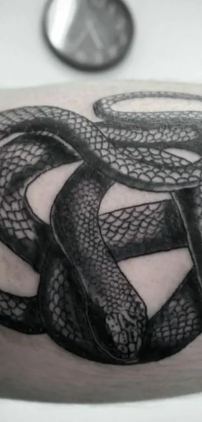 Intricate black snake tattoo design on an arm with detailed artwork.