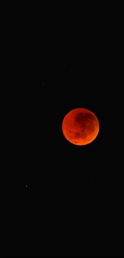 Blood moon on a dark, starry background wallpaper.