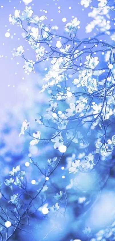 Ethereal blue flowers on branches against a luminous background.