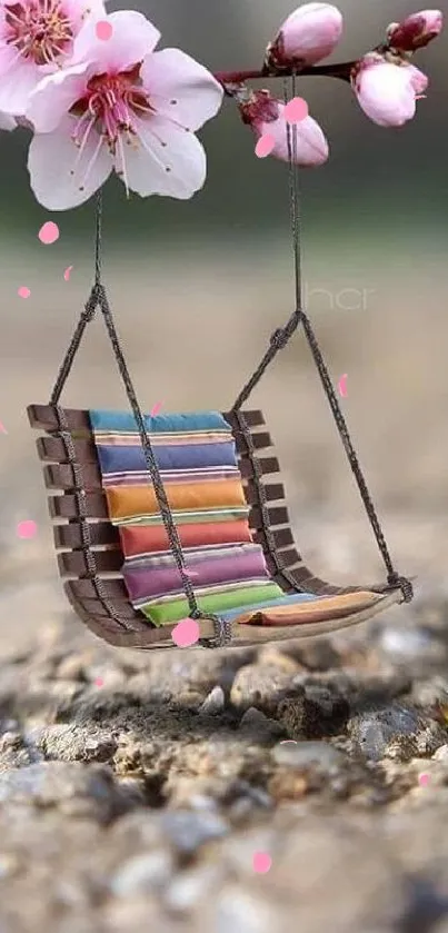 Pink blossom with wooden swing on rocky ground wallpaper.