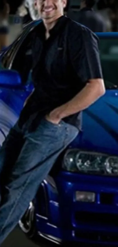 A person leaning on a blue sports car with nighttime vibes.