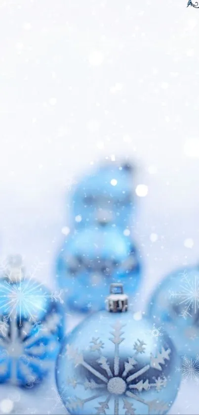 Blue Christmas ornaments with snowflakes in a serene winter-themed wallpaper.