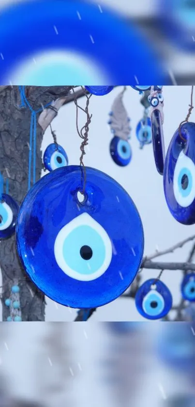 Hanging blue evil eye charm mobile wallpaper.