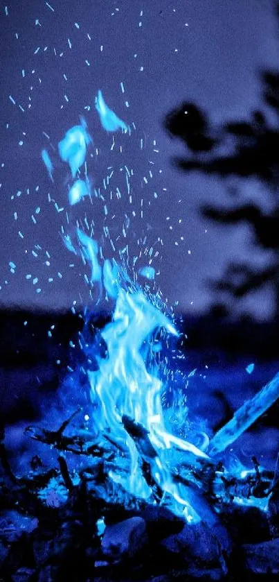 Mobile wallpaper with glowing blue flames at night.