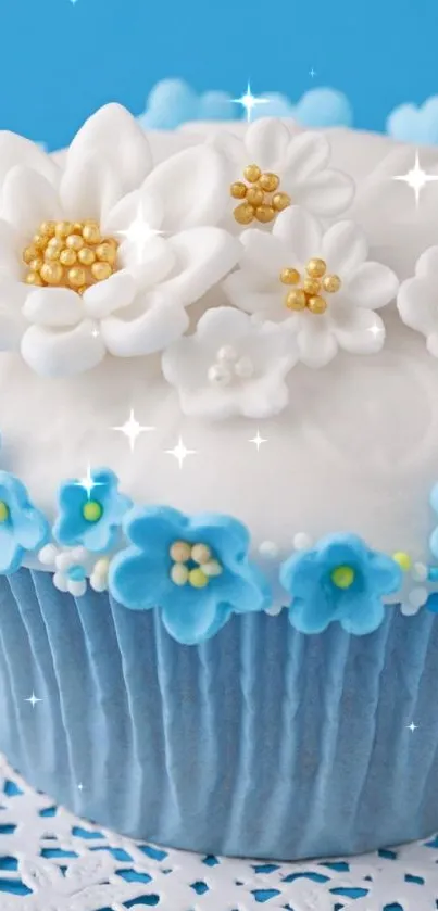 Blue cupcake with floral decorations on white doily