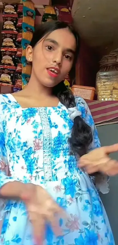 Woman in blue floral dress, vibrant background.