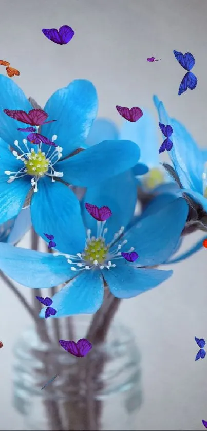 Blue flowers in a glass vase against a soft neutral background.