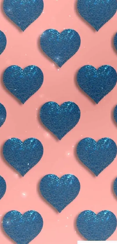 Blue glitter hearts on a pink backdrop in a repeating pattern.