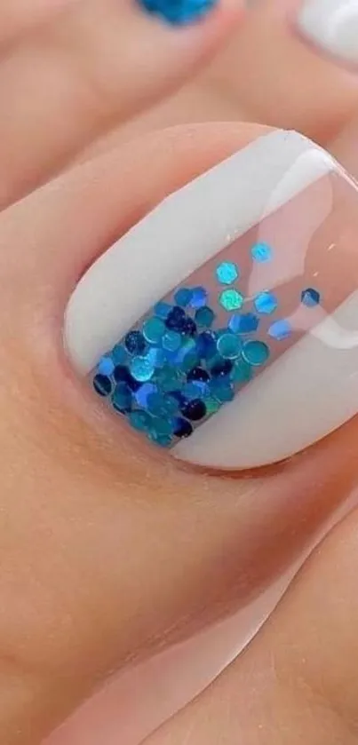 Close-up of blue glitter nail art, perfect for mobile wallpaper.