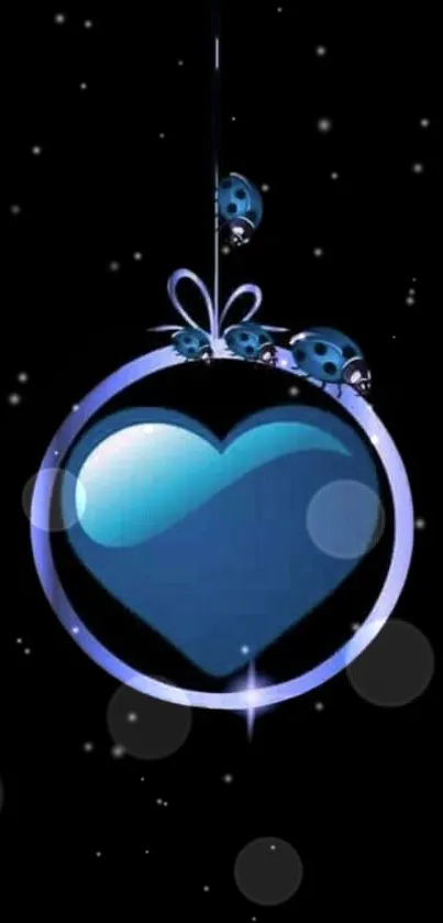 Blue heart ornament with ladybugs on black background wallpaper.